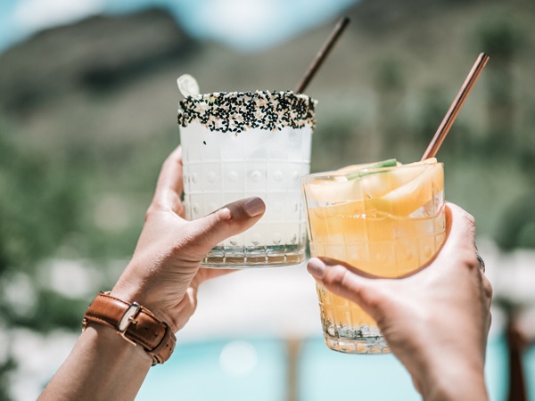 A photo of two people holding up cocktail drinks