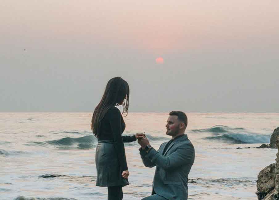 man proposing to a woman on the beach